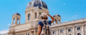 University student with a backpack exploring a historic European city – affordable student travel idea.