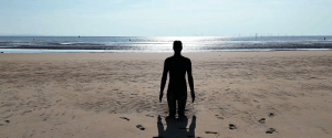 Antony Gormley's Another Place. An statue of an iron man on Crosby Beach, a Liverpool hidden gem attractions
