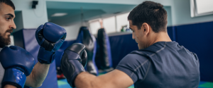 A male university student training in a boxing gym