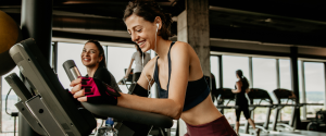 Two female university students working out in a gym that offers student discounts