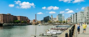 Two university students following a running route along the Liverpool waterfront