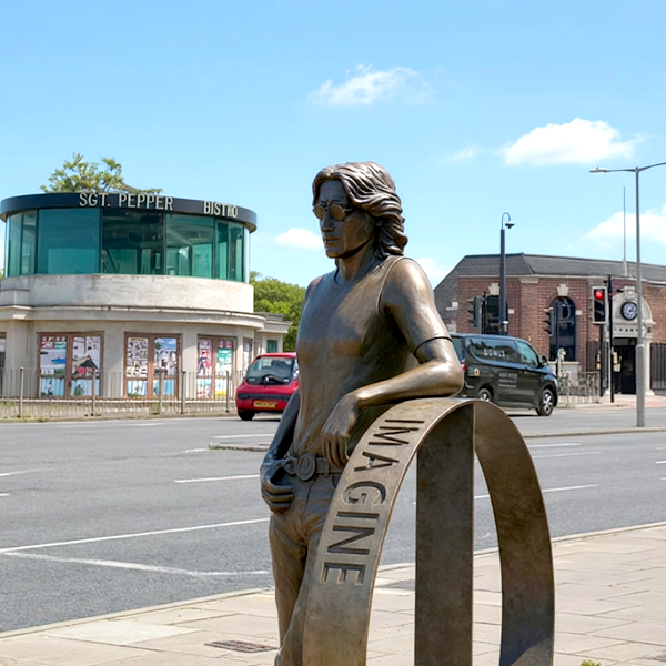 Statue of John Lennon holding an 